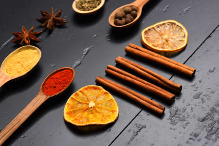 Composition of condiment. Set of spices on dark grey background.の写真素材