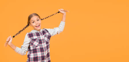 carefree beauty. child cute blond hair. childhood happiness. happy childrens day. small girl checkered jacket. autumn time. hipster girl yellow background. happy school girl casual style. kid fashionの写真素材