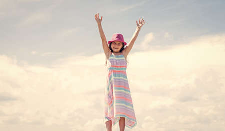 Young and beautiful. stylish cute child posing in spring. Summer fun and leisure concept. fashion model posing. her trendy style. sense of freedom. Stylish fashion child baby girl kid outdoorの写真素材