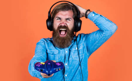 oh no. concept of tv gaming. man in headphones with console. hobby. just have fun. new technology in modern life. happy gamer play computer games. man playing video games. online gameの写真素材