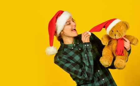 Playful lady smiling face. Play with toy. Santa Claus. Pretty woman celebrate christmas. Christmas memories from childhood. Girl with teddy bear. Charity and kindness. Lovely hug. Christmas spiritの写真素材