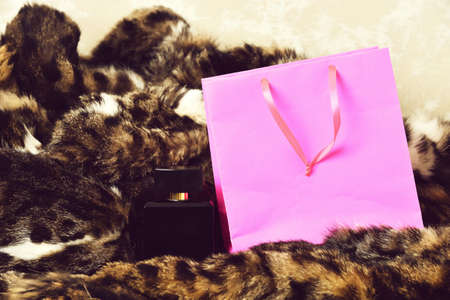 Pink shopping holiday package and perfume bottle as present