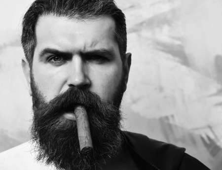 Bearded brutal caucasian hipster smoking cigarの写真素材