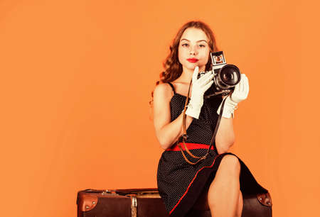 In her own style. SLR camera. beautiful child photographer hold retro camera. travel journalist...