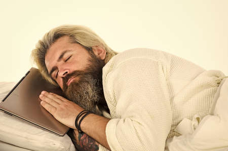 Inseparable from gadgets. Blue Light Effect. Man with sleepy face lies on pillow with laptop. Deep...