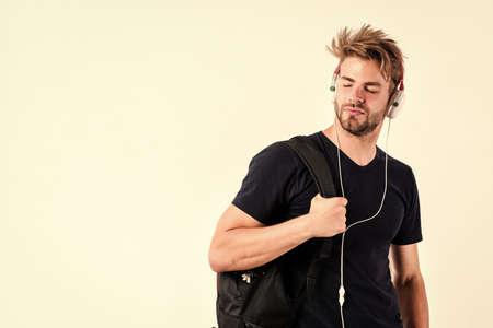 Download music application. Modern people concept. Youth music taste. Student handsome guy listening...