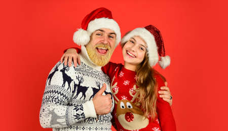 togetherness. winter xmas mood. new year is here. bearded dad and small girl santa hat. funny knitted sweater. father and daughter celebrate christmas. xmas party together. they love family holidayの写真素材