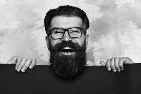 bearded man with happy face in glasses on colorful backgroundの写真素材