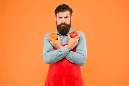 Organic crops. Tomato diet. Salesman with tomatoes. Bearded man hold tomato in hands. Tomato salsa or ketchup. Healthy cooking and eating. Farm market concept. Selling homegrown ripe vegetablesの写真素材