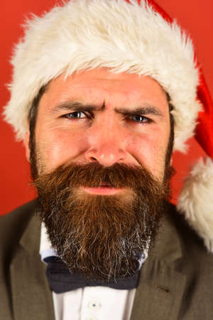 Businessman with suffering face in close up on red backgroundの写真素材