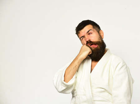 Karate man with suffering face in uniform. Japanese martial artsの写真素材