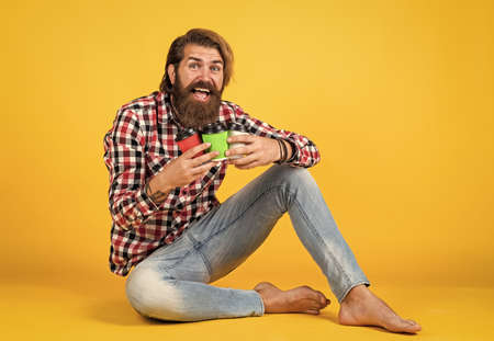 he likes all. man drink hot tea from paper cup. good morning. energetic warm take away beverage. need some coffee to go for inspiration. happy bearded man drinking morning coffeeの写真素材
