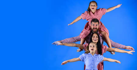 mother and father spend time with their cheerful little girls, family