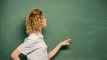 Just look here. Pay attention. Teachers enlighten path of success. Woman teacher in front of chalkboard. Important information to remember. Teacher friend of learners. Teacher explain hard topicの写真素材