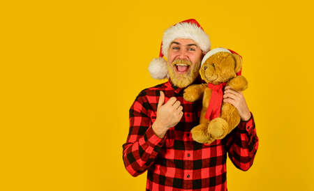 Christmas time for mercy. Charity project. Bearded man celebrate christmas. Kind hipster with teddy bear. Charity and kindness. Lovely hug. Santa Claus. Mature man with long beard. Christmas spiritの写真素材