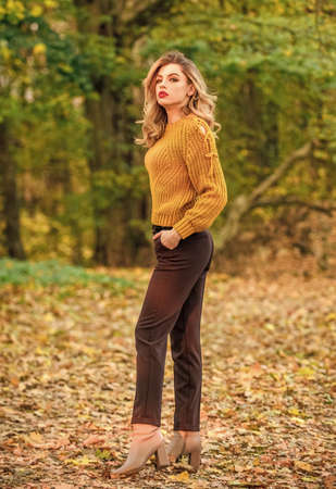 Breathtaking landscape. beautiful fashion model in knitwear sweater. feeling romantic in fall...