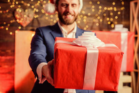 Celebrate christmas corporate party. Man formal suit hold gift box. Christmas gift from colleague....