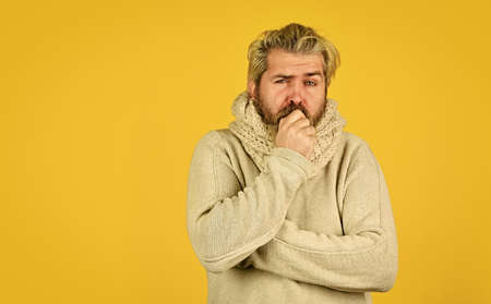 Body temperature. Fever and thermal regulation of immunity. Bearded man sick. Warm scarf around neck. Hipster fever. Cold flu fever concept. More than just symptom of illness. Regulate immune systemの写真素材