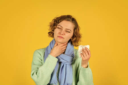 feel so sick. concept of treating allergies or colds. runny nose. woman with allergy blowing nose. Coronavirus outbreak concept. sick woman sneezing at home. Holding Handkerchief to her Runny Noseの写真素材