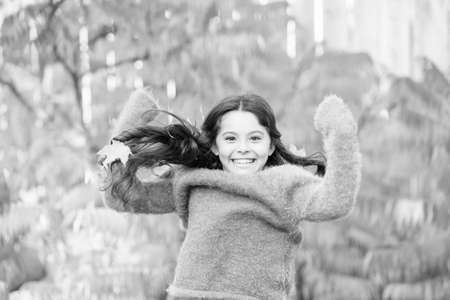 Simple happiness. Kid enjoy autumn outdoors. Meet autumn. Little girl smiling happy cute child gorgeous long hair maple leaves. Cozy autumn day. Play with leaves. Happy childhood. Fall festivalの写真素材