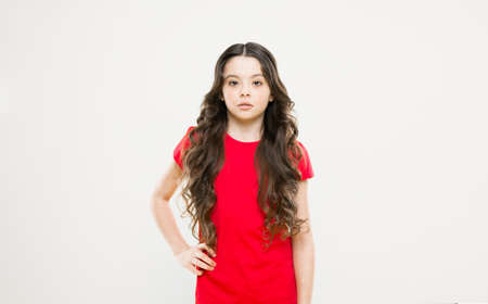 Kid cute face with adorable curly hairstyle. Little girl grow long hair. Teen fashion model. Styling curly hair. Change you can see. Hairdresser tip. Kid girl long healthy shiny hair. Perfect curlsの写真素材