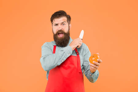 Mature man hold knife and vegetable. Chef prepares meal. Safe cutting. Cutting veggies. Ultimate list of cutting techniques every chef should know. Bearded man prepare tomato. Fresh salad recipeの写真素材