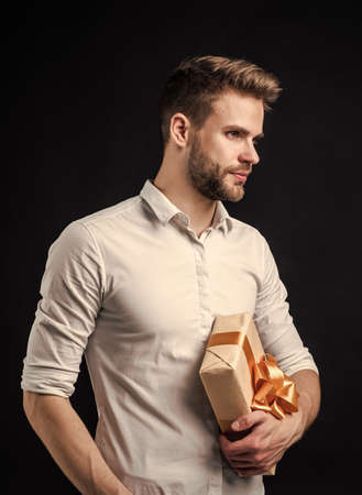 I want to buy this. pure party goer. funny man with gift box. guy hold present. happy holiday celebration. time for fun and presents. happy birthday or anniversary. feel cheer and joyの写真素材