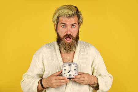 Late again. Destroy the Clock. handsome angry man indoors wake up turn off the alarm clock. Tired man in bedroom not happy. suffering insomnia and sleep disorder. bedtimeの写真素材