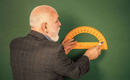 no mistakes. Education and school concept. home learning. senior man teacher use protractor tool. bearded tutor man draw with ruler on blackboard. back to school. favorite subject and disciplinesの写真素材
