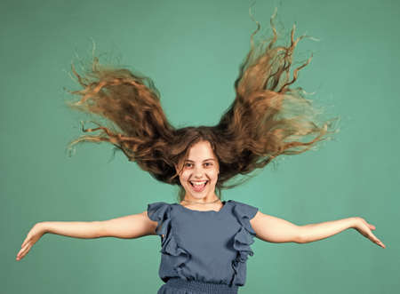Fashion concept. kid beauty and fashion. hairdresser beauty salon. childhood happiness. little fashion model. small girl wear dress. child with happy smile. looking so stylish. perfect healthy hairの写真素材