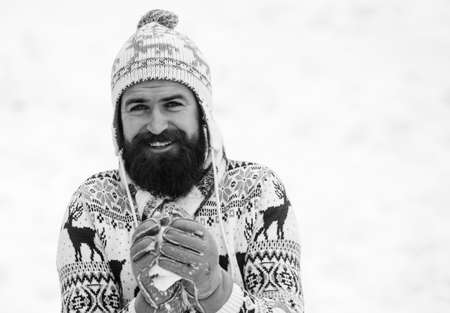 Snow games. Have fun winter day. Cheerful bearded hipster knitted hat and warm gloves play with snow...