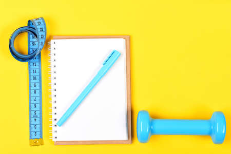 Sport instruments in cyan blue color. Notepad, pen and gymの写真素材