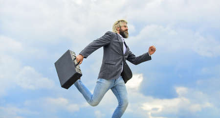 Carefree thief. Business man formal suit carries briefcase. Illegal deal business. Feel impact. Steal something. Hipster hold briefcase with bribe. Businessman run away business case. Happy workerの写真素材