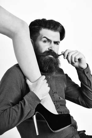 bearded man with sexy female leg has serious faceの写真素材