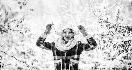 Cheerful girl outdoors. joyful and energetic woman. skiing holiday on winter day. beautiful woman in warm clothing. Enjoying nature wintertime. Portrait of excited woman in winterの写真素材
