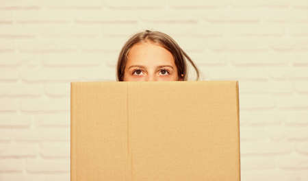 delivery. little girl with box. moving to new apartment. perfect purchase. moving concept. move to new house. rent concept. repair annd relocate. happy childhood. copy space. small girl childの写真素材