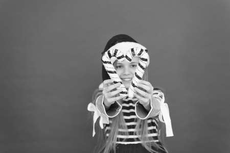 Christmas decor. Striped candy cane traditional for winter holidays. Her favorite season. Christmas decorating ideas. Child Santa Claus hat hold christmas candy cane red background. Decorations shopの写真素材