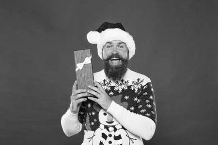 Christmas gift concept. Man celebrate winter holiday. Hipster in winter sweater. Winter season holidays. Box in his hands. Santa gave me present. Joyful shopping. Favorite tradition. Happy new yearの写真素材