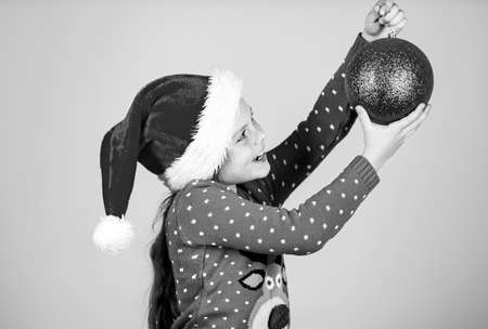 Want to put it. winter holiday and xmas joy. seasonal shopping discount. small girl decorative ball present. big christmas sale. child santa hat gift. all i dream about. happy new yearの写真素材