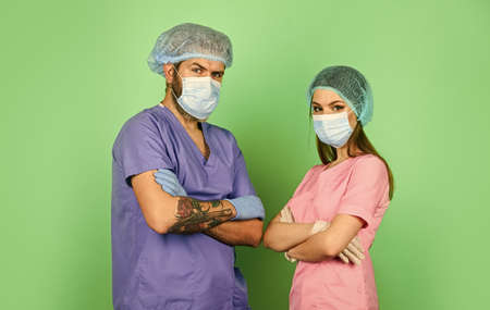 High quality care. nurse and doctor wear respirator mask. surgeon after surgery operation.  healthcare. Successful team of medical doctors. qualified medicine staffの写真素材