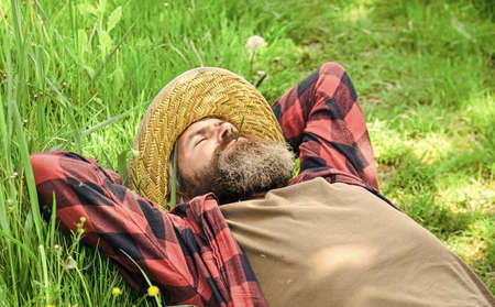 United with motherland. Nature is my home. Farmer bearded man rest after day work. Farmer relax on green grass. Ecology concept. Summer vacation. Rest in countryside. Eco environment. Summer restの写真素材