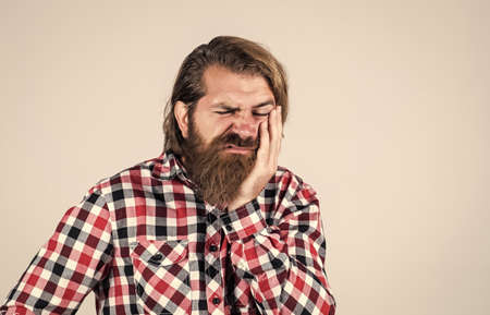 dentist consultation. Handsome bearded man in casual clothes. Suffering Caucasian Man. brutal bearded hipster has toothache. male feel pain in teeth. casual male need medical careの写真素材