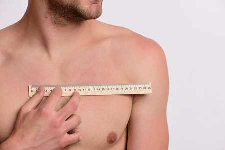 Measurement and size concept. Athlete with naked bodyの写真素材