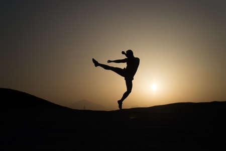 Hit your goal. Silhouette man motion jump in front of sunset sky background. Daily motivation. Healthy lifestyle personal achievements goals and success. Future success depends on your efforts nowの写真素材