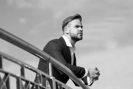 Businessman on blue sky. Manager in business suit outdoor. Bearded man on sunny day. Business fashion, style and dress code. Career, success and future conceptの写真素材