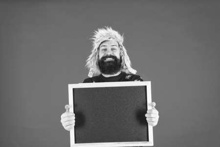 Learn barbering, become barber. Happy barber hold blackboard. Bearded man advertising barber school. Barber shop. Barbershop, copy spaceの写真素材