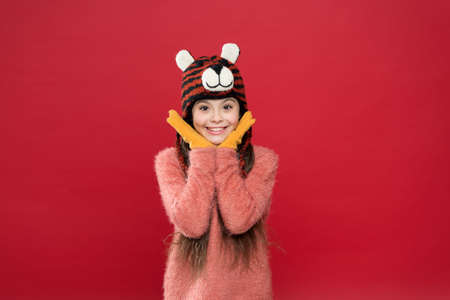 What a great surprise. feel comfortable and cozy in any weather. winter holiday and vacation. kid in hat with ear flaps. child in knitted sweater. happy childhood. happy teen girl wear warm clothesの写真素材