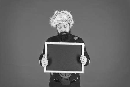 Additional services. Winter announcement. Bearded hipster man blank blackboard copy space. Santa Claus advertisement. Chalkboard information. Seasonal offer. Christmas offer. Special offer conceptの写真素材