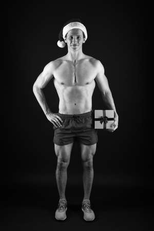 Boxing day offer. Happy man hold gift box. Athletic Santa celebrate boxing day. New year blowout. Boxing day sale. Christmas shopping. Shop now. Happy boxing day. December 26の写真素材