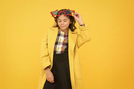 Popular schoolgirl. Carnival costume famous celebrity. Rock star. Party holiday celebration. Cheerful girl wear eyeglasses for fun. Cool kid star shaped sunglasses. Star concept. Fame and popularityの写真素材